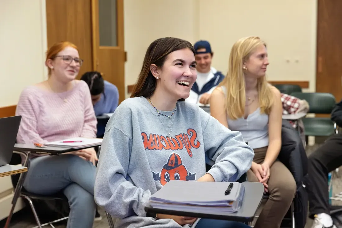 Student smiling in classroom.